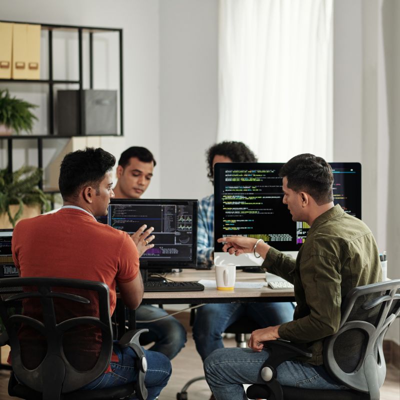 Software Engineers Writing Code In Front Of Computers