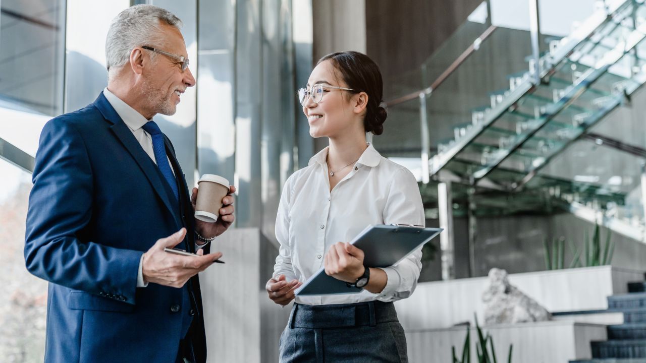 Business Man And Woman Having A Converdsation Standing Up