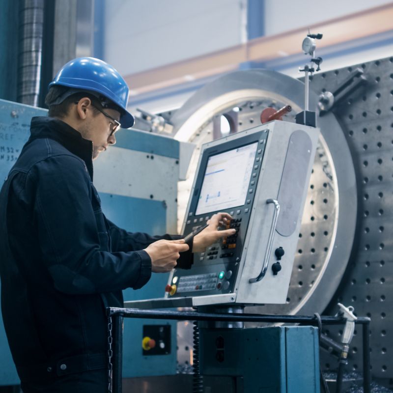 Engineer Working On Machine Screen