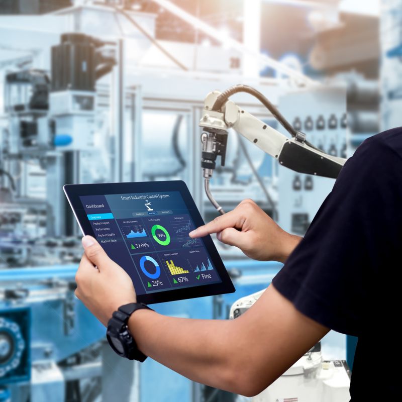 Person Using Tablet Infront Of Machines